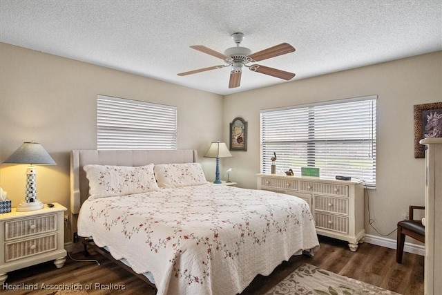 bedroom featuring ceiling fan, a textured ceiling, and dark hardwood / wood-style floors