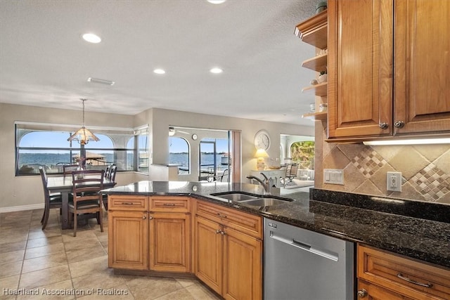 kitchen featuring decorative light fixtures, dishwasher, a water view, and an inviting chandelier