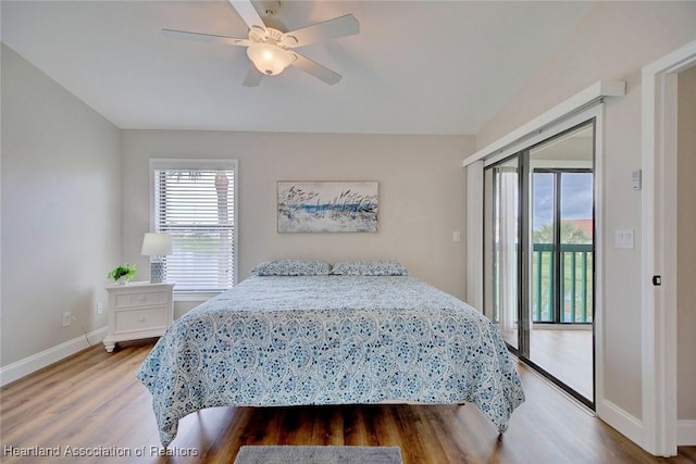 bedroom featuring hardwood / wood-style floors, access to outside, and ceiling fan