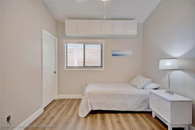 bedroom featuring ceiling fan and light hardwood / wood-style floors