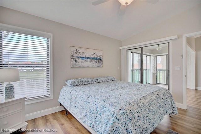 bedroom featuring ceiling fan, a closet, light hardwood / wood-style flooring, and vaulted ceiling