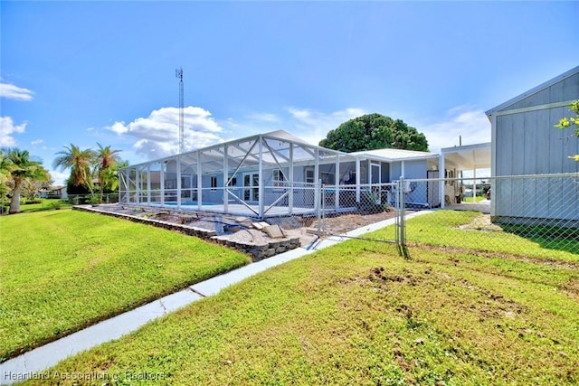 rear view of house with glass enclosure, a yard, and a swimming pool