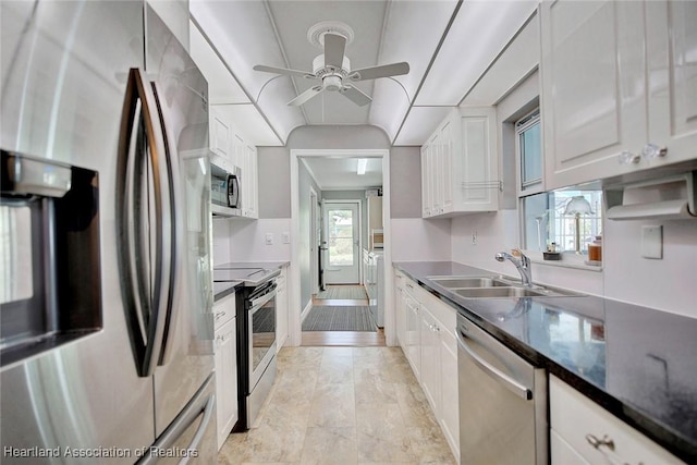 kitchen featuring white cabinetry, sink, stainless steel appliances, and plenty of natural light