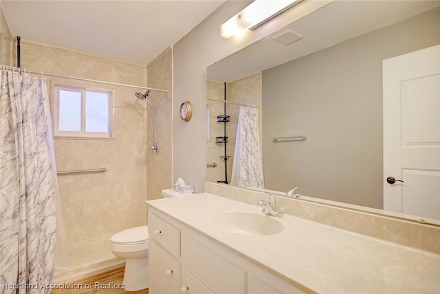 bathroom with hardwood / wood-style flooring, vanity, curtained shower, and toilet