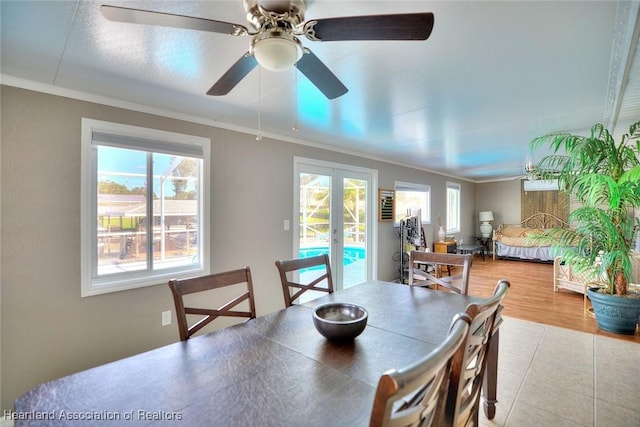 dining area featuring ceiling fan, french doors, and ornamental molding