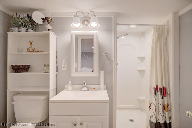 bathroom with a shower with curtain, toilet, vanity, and ornamental molding