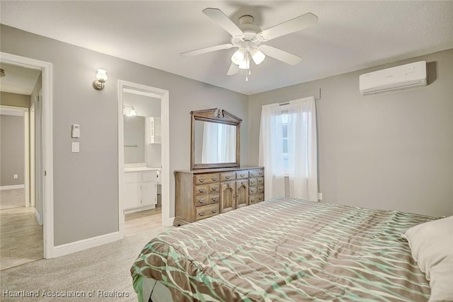 carpeted bedroom with a wall mounted AC, ceiling fan, and ensuite bathroom