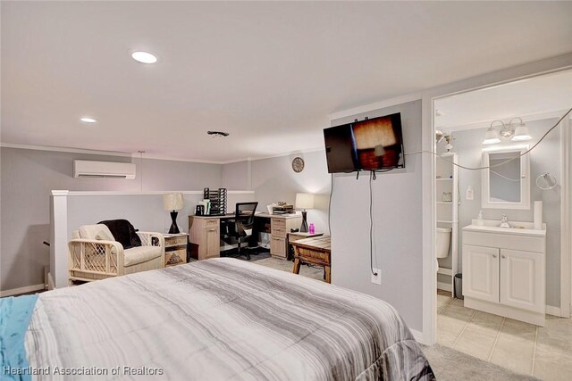 bedroom featuring a wall mounted air conditioner, light tile patterned floors, ensuite bathroom, and sink