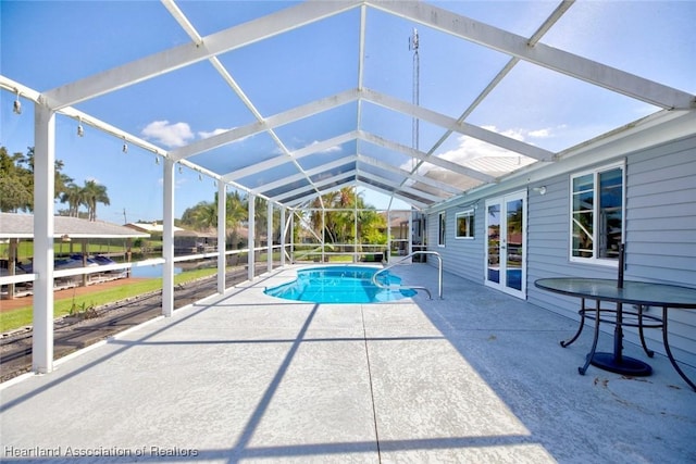 view of pool with a lanai, a patio area, and french doors