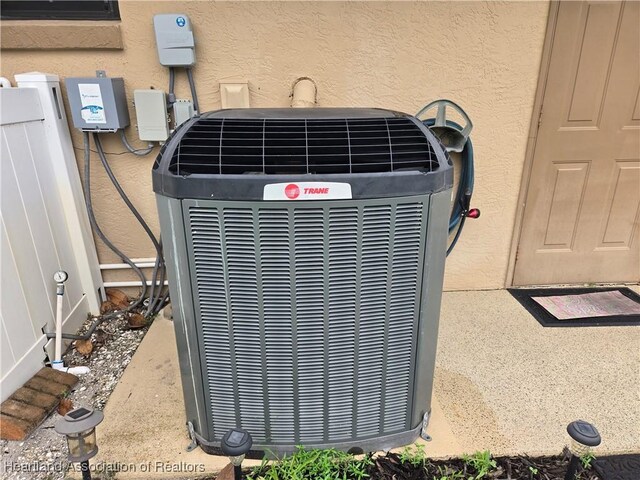 55 Lake Side Trl, Lake Placid, FL 33852 - exterior view of cooling unit and stucco siding