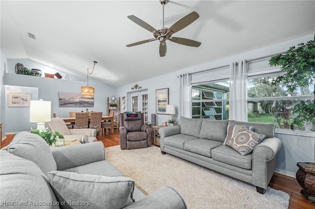 living room featuring lofted ceiling, ceiling fan, and wood-type flooring