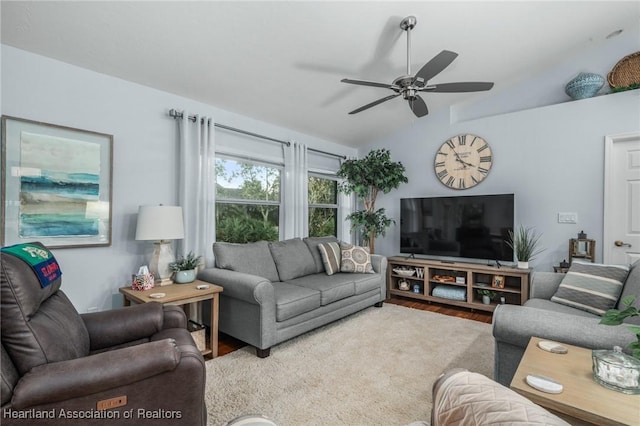 living room with ceiling fan, wood-type flooring, and vaulted ceiling