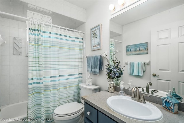 full bathroom with vanity, shower / tub combo, and toilet