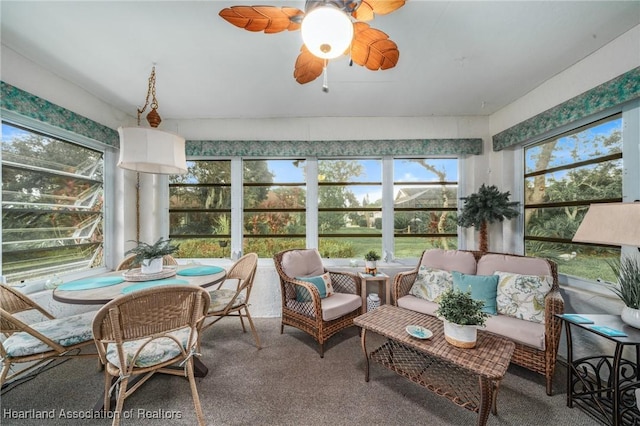 sunroom / solarium featuring a wealth of natural light and ceiling fan