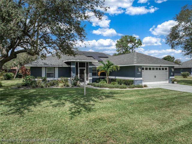 view of front of house featuring a front yard, solar panels, and a garage