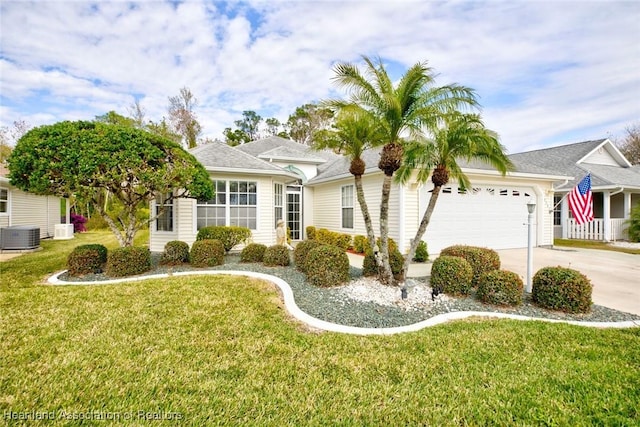 ranch-style home with a garage, a front yard, and central AC