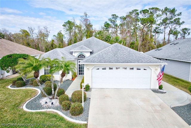 view of front of property featuring a front lawn and a garage