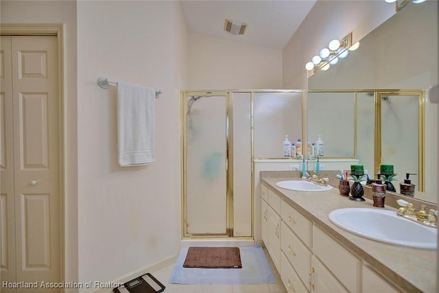 bathroom with vanity, tile patterned flooring, and walk in shower