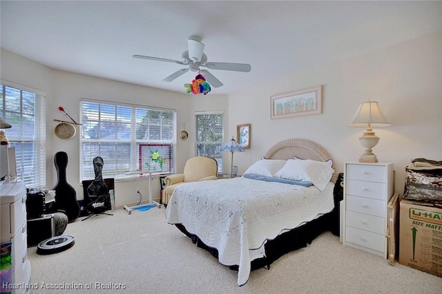 bedroom with ceiling fan and carpet floors