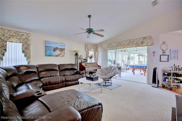 carpeted living room with ceiling fan and lofted ceiling