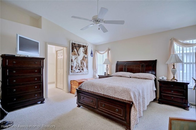 carpeted bedroom with ceiling fan and vaulted ceiling