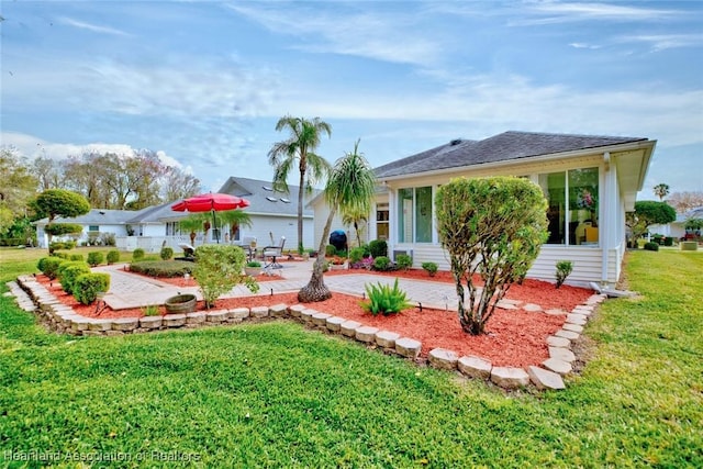 back of house featuring a yard and a patio