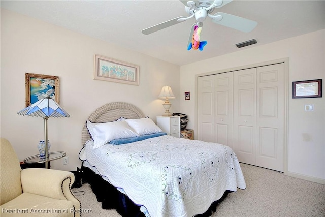 carpeted bedroom with ceiling fan and a closet