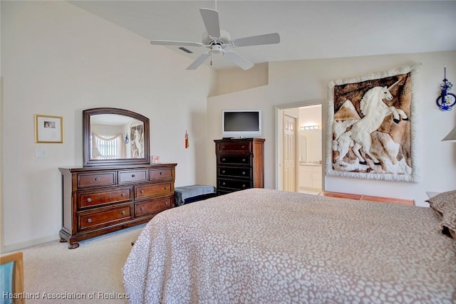 carpeted bedroom with ceiling fan, ensuite bathroom, and vaulted ceiling