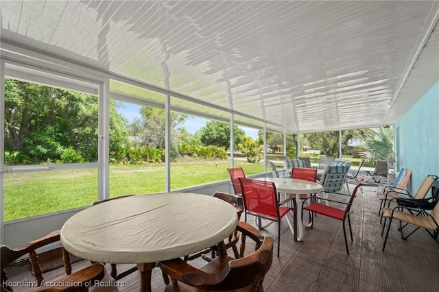 sunroom / solarium featuring outdoor dining space