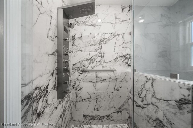 full bath with a marble finish shower