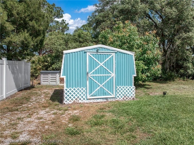 view of shed with fence