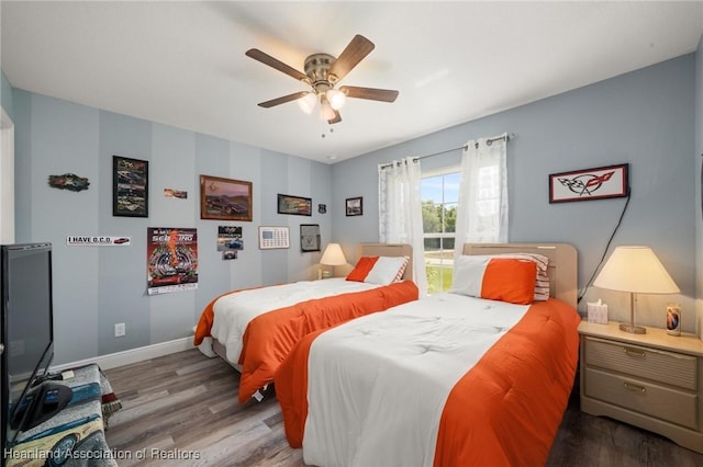 bedroom with baseboards, wood finished floors, and ceiling fan
