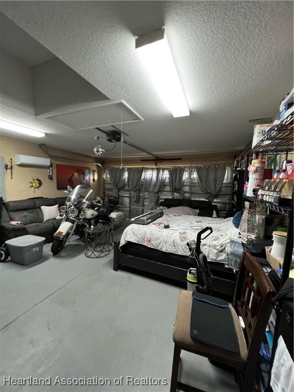 bedroom with concrete flooring, a wall mounted AC, and a textured ceiling