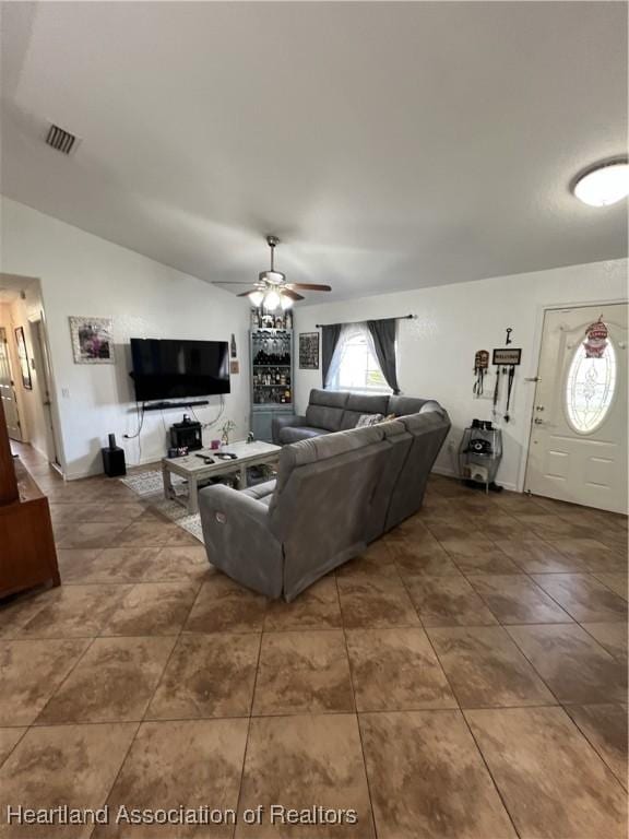 tiled living room with vaulted ceiling and ceiling fan