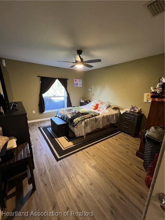 bedroom featuring hardwood / wood-style flooring and ceiling fan