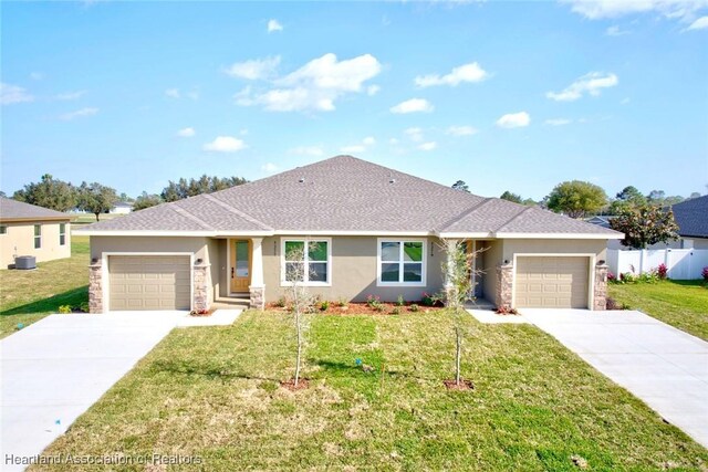 single story home featuring a front yard and a garage