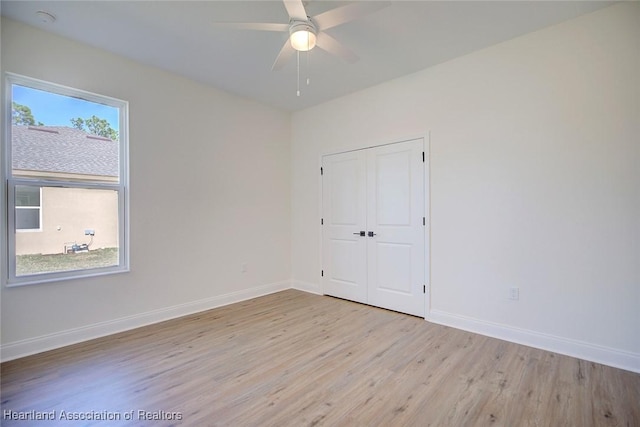 unfurnished room featuring ceiling fan and light wood-type flooring