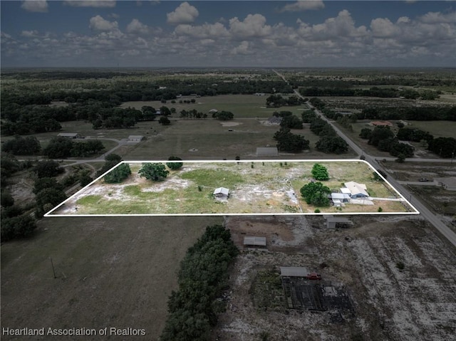 birds eye view of property with a rural view