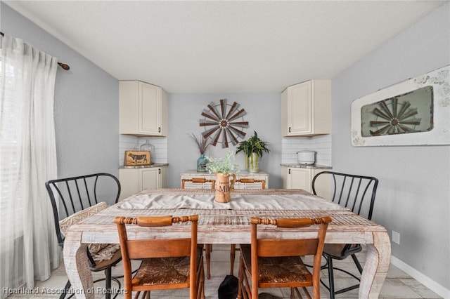 dining space featuring baseboards