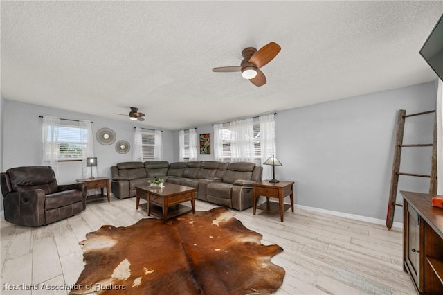 living room featuring a textured ceiling, wood finished floors, and a ceiling fan