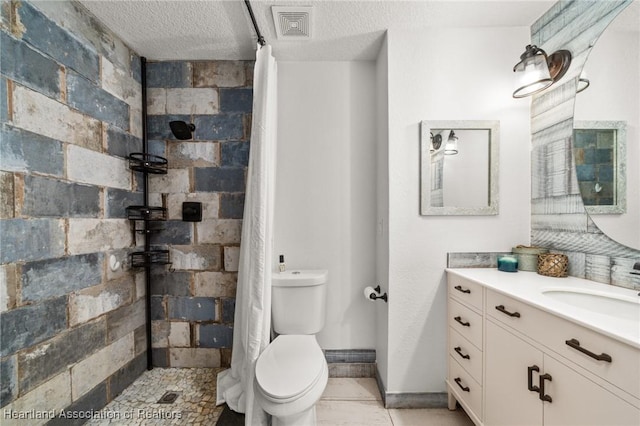 bathroom featuring a textured ceiling, a tile shower, visible vents, toilet, and vanity