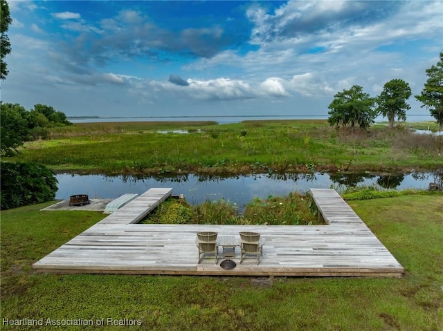 dock area featuring a yard and a water view