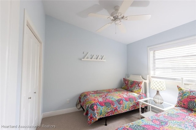 bedroom with carpet flooring, ceiling fan, and a closet