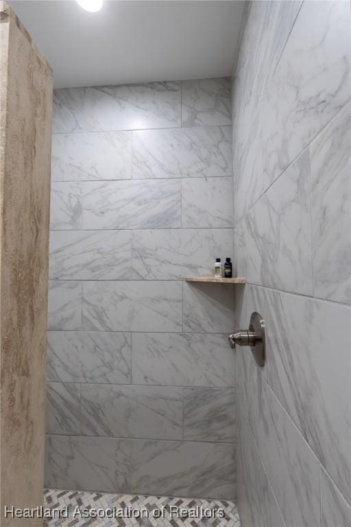 bathroom with a tile shower