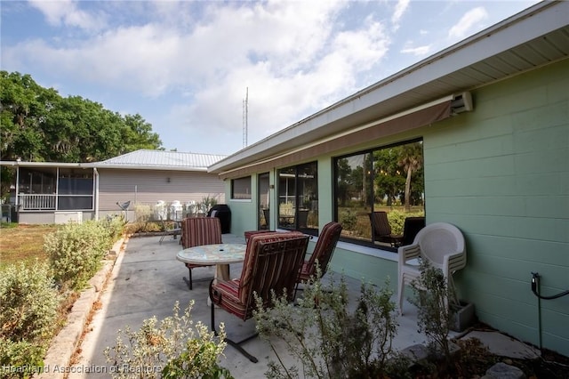 view of patio featuring a sunroom
