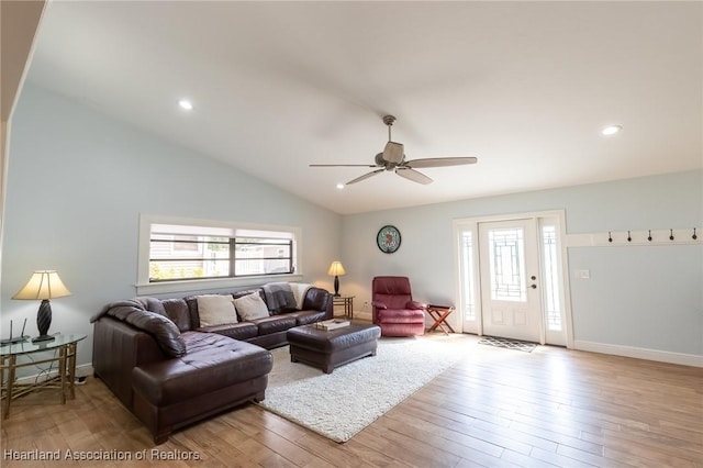 living room with light wood-type flooring, vaulted ceiling, and ceiling fan
