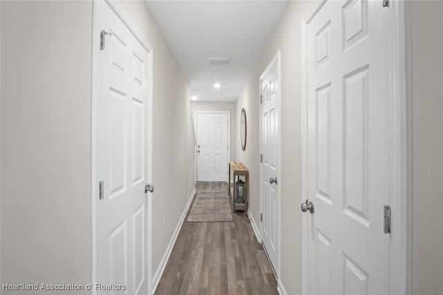 corridor featuring dark hardwood / wood-style floors