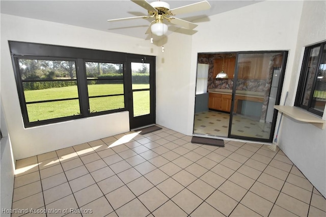 spare room with light tile patterned floors and ceiling fan