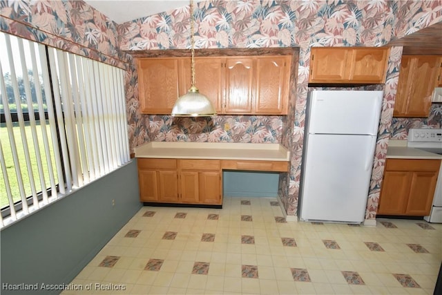 kitchen featuring stove, white refrigerator, and extractor fan