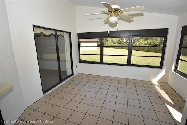 unfurnished sunroom with ceiling fan